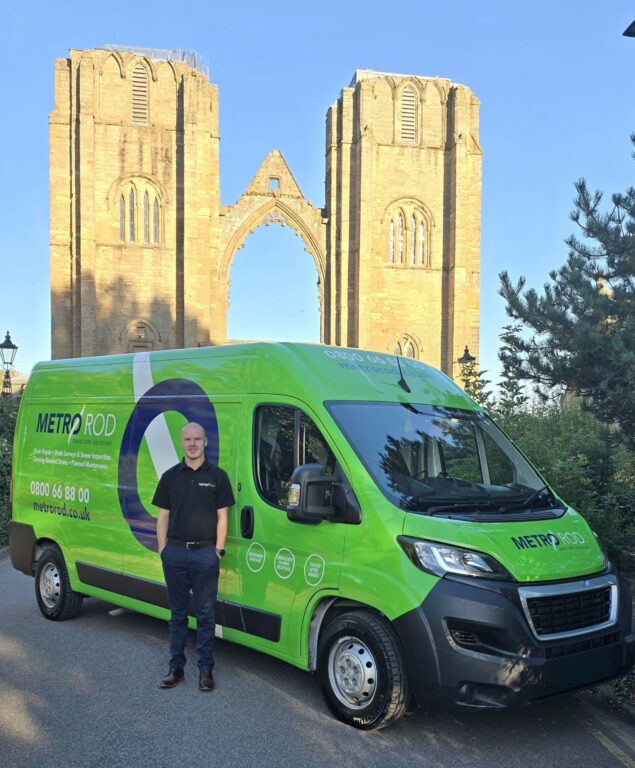 Gregor Hands, Franchisee At Metro Rod Highlands & Islands, stood in front of a Metro Rod van